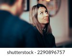 Small photo of Funny Woman Feeling Bored Talking to her Boyfriend. Wife rolling her eyes at her husband arguments