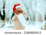 Small photo of Unhappy Woman Checking her Gift Bag being Ungrateful Upset lady feeling underwhelmed by holiday seasonal stress