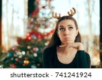 Sad Bored Woman Having No Fun At Christmas Dinner Party - Funny girl wearing reindeer horns headband at Xmas Party
