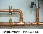 Copper pipework with isolator valve, close up view.