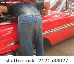 Mechanic man checking engine of ...