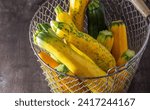 Small photo of Yellow green leopard spotted zucchini. Vegetables on the table. vegetable marrow harvest. Food background. Fresh courgette, cropped summer squash. Picked courgettes. Still life in kitchen.