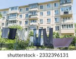 Laundry dries on washing line in courtyard of Khrushchyovka, a common type of old low-cost apartment building in Russia and post-Soviet space. Life in Russia. Russia, Vladivostok.