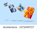 Many Flying Gift Boxes on a light blue background. Holiday concept, gift, sale, wedding and birthday.