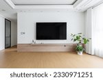 Small photo of Blank modern flat screen TV hanging on wall in living room