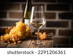 White wine in a glass with fall grapes, dark wooden background