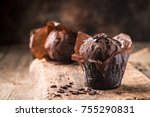 Homemade delicious chocolate muffin on wooden background close-up