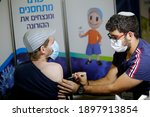 Small photo of A medical worker inoculates a recipient with a COVID-19 vaccine in Jerusalem, Jan. 10, 2021.