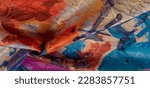 Small photo of silk fabric in a painted artistic palette, abstract drawing, bright colors, red-yellow-blue color, unrestrained imagination. texture, background, pattern
