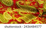 Small photo of Paisley green pattern on a red background. decorated the bandanas of cowboys and bikers popularized by The Beatles, ushered in the era of hippies and became the emblem of rock and roll.