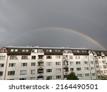 Small photo of Rainbow in the city over eht hills and houses. Slovakia