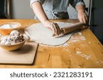 Small photo of kid-boy making dumplings, pierogi , varenyky, served with cottage cheese lay in sieve. National Ukraine cuisine, natural organic homemade bakery product