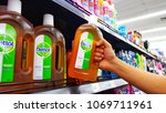 Small photo of Sriracha, Chonburi THAILAND April 12, 2018: Man's hands are holding Dettol products on the shelves at supermarket. Dettol is a famous brand for antiseptic germicide and health care.