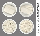 Small photo of Processed white tofu, in white bowls, isolated on gray background. A block, slices, cubes, and crumbled tofu. Bean curd, made of coagulated soy milk, a component of Asian cuisine and meat substitute.