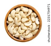 Small photo of Cashew nuts, raw cashews in a wooden bowl. Seeds of shelled cashew tree fruits, Anacardium occidentale. Snack nuts, can be eaten on its own, used in recipes or processed into cashew butter or cheese.