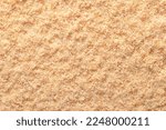 Small photo of Wood flour, wood powder, fine sawdust, close-up, surface from above. Formed by sawing dried spruce. Finely pulverized wood, a by-product and waste product, mainly used as a filler and extender.