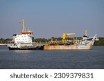 Small photo of Samut Prakan, Thailand-May 20 2023: Sandon 9 Dredger ship of Port Authority of Thailand weigh anchor in the Chaopraya river.