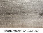 Small photo of The relief texture of the surface of the old wooden board with poor processing, the expressive direction of the wood fibers and the cutoff point of the knot
