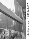 Small photo of black and white picture of long blind,jalousie,curtain, Louvers , shade, sunblind, roller, shutter protected sunlight background and glass room.