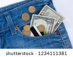 Small photo of Wallet, credit cards and ready money are lying in side pocket of blue jeans