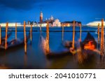 Night view of San Giorgio Maggiore with famous gondolas. Long exposure landscape. San Marco, Venice, Italy.