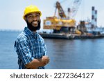 Small photo of Black offshore worker with digger and plattform and ship at blue ocean