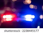 Small photo of Police car with flashing lights at night
