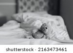 Teddy Bear Is Lying On Bed In...