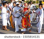 Small photo of Phuket, Thailand - Oct 2016: Man with piercing made from real bike. Unusual person who inserted bicycle frame in cut on his cheek at street procession in honor of religious Phuket Vegetarian Festival
