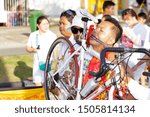 Small photo of Phuket, Thailand - Oct 2016: Man with piercing made from real bike. Unusual person who inserted bicycle frame in cut on his cheek at street procession in honor of religious Phuket Vegetarian Festival