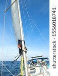 Small photo of White sails and blue sky in the tropics. Sailing yacht on vacation in the ocean. Mast, boom, halyard, wind-filled sails - jib, spinnaker, genoa, mainsail. Rig, rope, backstay in Thailand