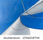 Small photo of White sails and blue sky in the tropics. Sailing yacht on vacation in the ocean. Mast, boom, halyard, wind-filled sails - jib, spinnaker, genoa, mainsail. Rig, rope, backstay in Thailand