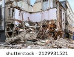 Ruined house after an earthquake Planks bricks