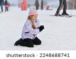 A Little Girl Making Snowballs...