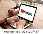 Small photo of Bangkok Thailand. MAR 28,2023 : Man using a laptop to connect to YouTube Premium website home page. YouTube is a video-sharing website, created by three former PayPal employees and owned by Google.