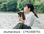Woman holding a Bible, a natural background, is faithful to God and love God’s word