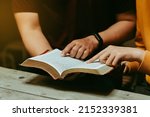 Christian couples read and study the Bible at home or in Sunday school. Sunday readings, spirituality, and religion Concept.