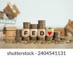 Small photo of The Federal Reserve ( FED ) to control interest rates. Wooden blocks FED on coins stack. American economy and business. Federal Reserve Bank Interest rates rise policy. FED concept.Inflation