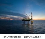 Small photo of Aerial view offshore drilling rig (jack up rig) at the offshore location during sunset