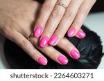 Stylish bright female pink manicure.  Manicure with gel polish close-up