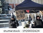 Small photo of Krakow, Poland - February 14 2021: Banner with text APOSTASY STOP and hashtags ENOUGH OF SILENCE and people offering help to start procedur officially leave the Catholic church, Krakow city center
