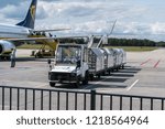 Small photo of EINDHOVEN, THE NETHERLANDS - AUG 25, 2018: Ryanair aircraft on the runway. Ryanair is a major company for low cost flights. Baggage car