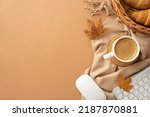 Small photo of Autumn business concept. Top view photo of cup of coffee rattan placemat wicker tray with croissants computer mouse keyboard yellow maple leaves and scarf on isolated beige background with copyspace