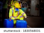 Small photo of Engineer industry wearing safety uniform ,black gloves ,gas mask feel suffocate when under checking chemical tank in industry factory work.