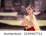 Small photo of Portrait Asian model posing to pay respect with smiling wearing Thai dress traditional costume greeting happy new year thailand songkran festival.