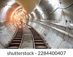 Soft focus and blurred lighting background of focus at railway.Engineer or technician control. Underground tunnel infrastructure. Transport pipeline by Tunnel Boring Machine for electric train subway.