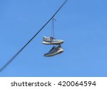 Shoes Dangling On A Cable Over...