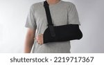 Small photo of Broken arm. Arm Sling therapy support and covered around elbow first knuckle broken arm. Post Operative Care. Fractures of humerus radius ulna scapula. Arm Sling after accident. Isolated background.