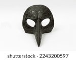 Small photo of Plague doctor mask isolated on white background. Medieval medical mask. Epidemics, diseases, virus and vintage concepts. Horizontal close-up.