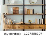 close up of wooden rack with books in living room 